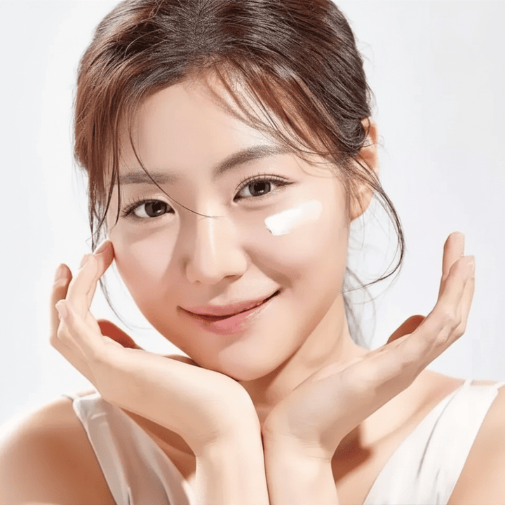 Femme appliquant Round Lab 1025 Dokdo Eye Cream sous les yeux pour l’hydratation, l’éclat et un teint plus uniforme