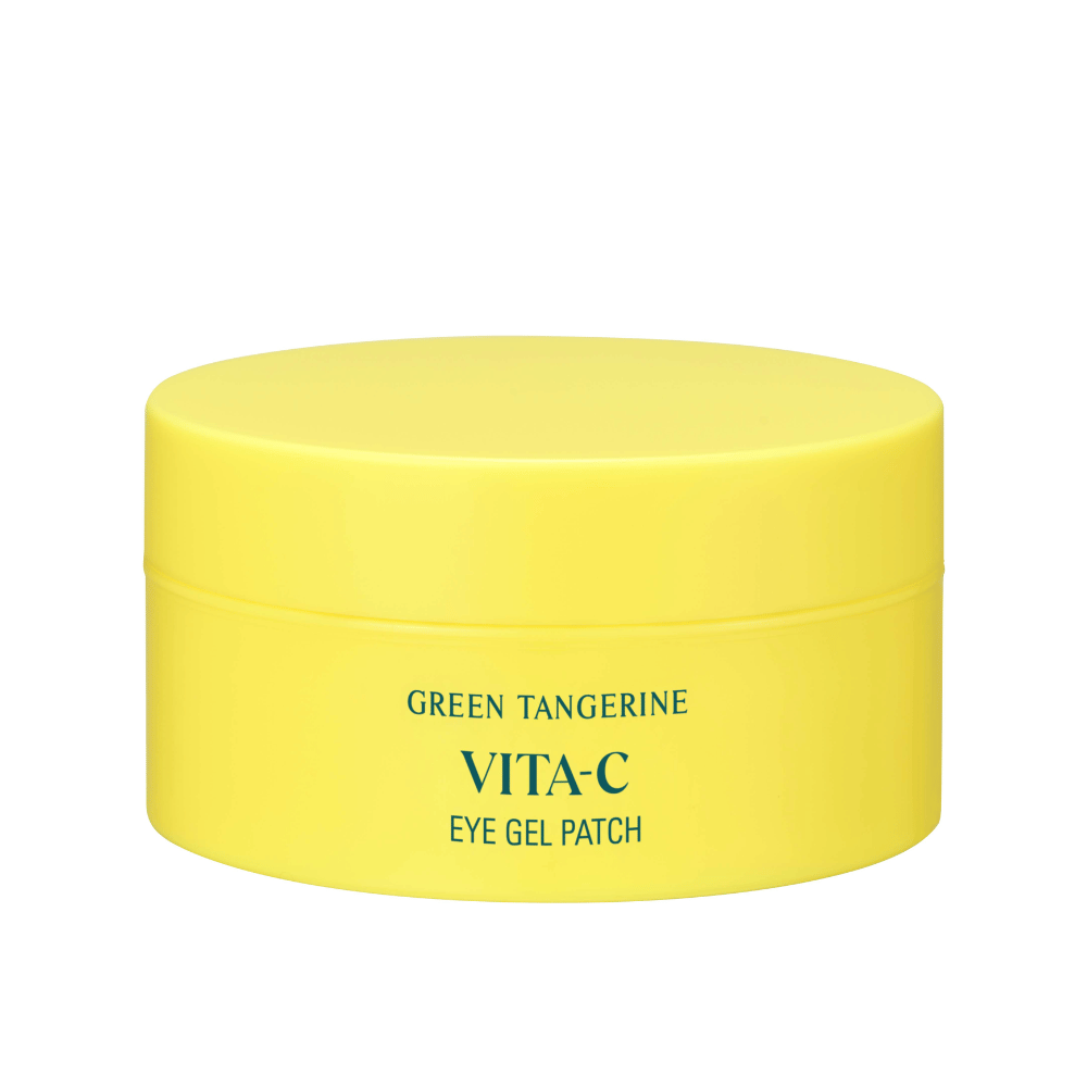 Un pot jaune marqué "GREEN TANGERINE VITA-C EYE GEL PATCH" probablement des masques pour les yeux contenant de la vitamine C.