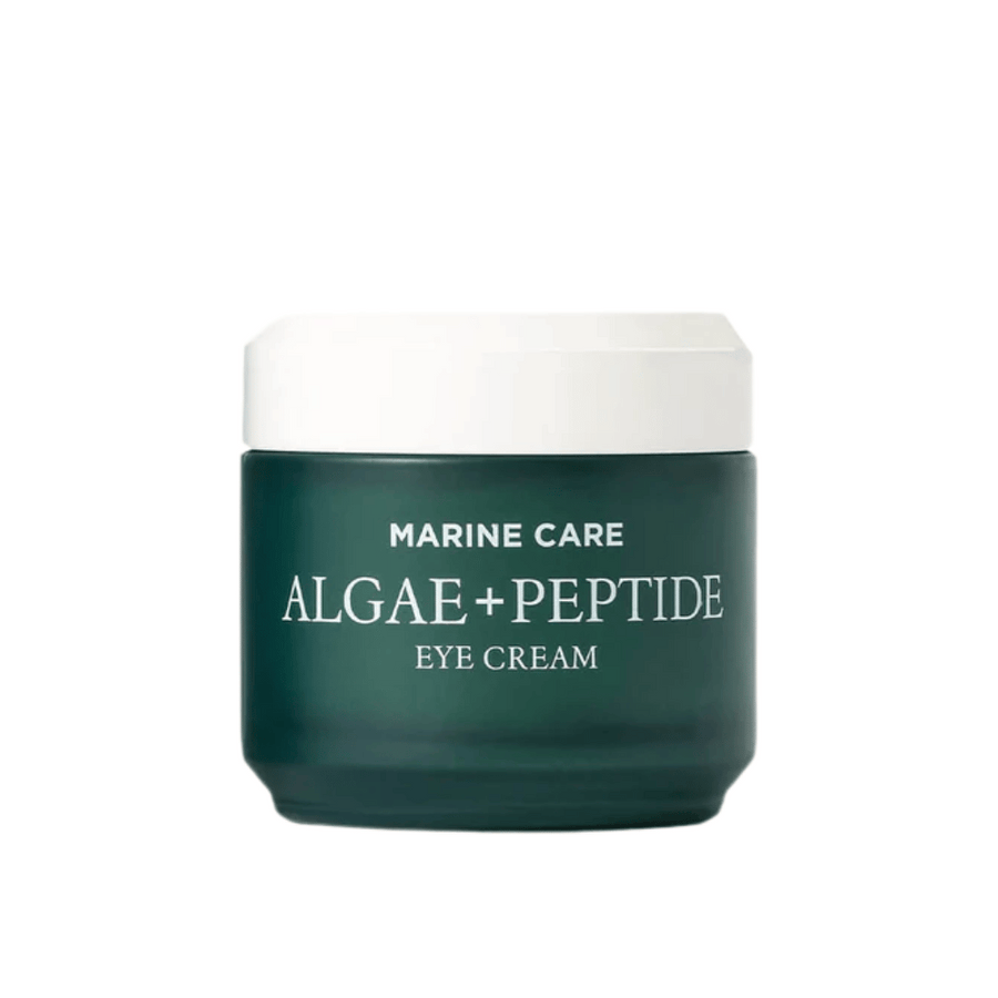 Heimish Marine Care Algae + Peptide Eye Cream dans un pot vert foncé avec un couvercle blanc. Une crème pour les yeux enrichie en algues et peptides pour hydrater, éclaircir et réduire les ridules autour des yeux.