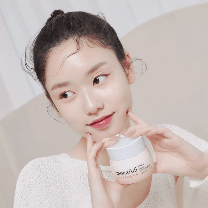 Femme tenant un pot "Moistfull Collagen Cream", chemise blanche, sourire.