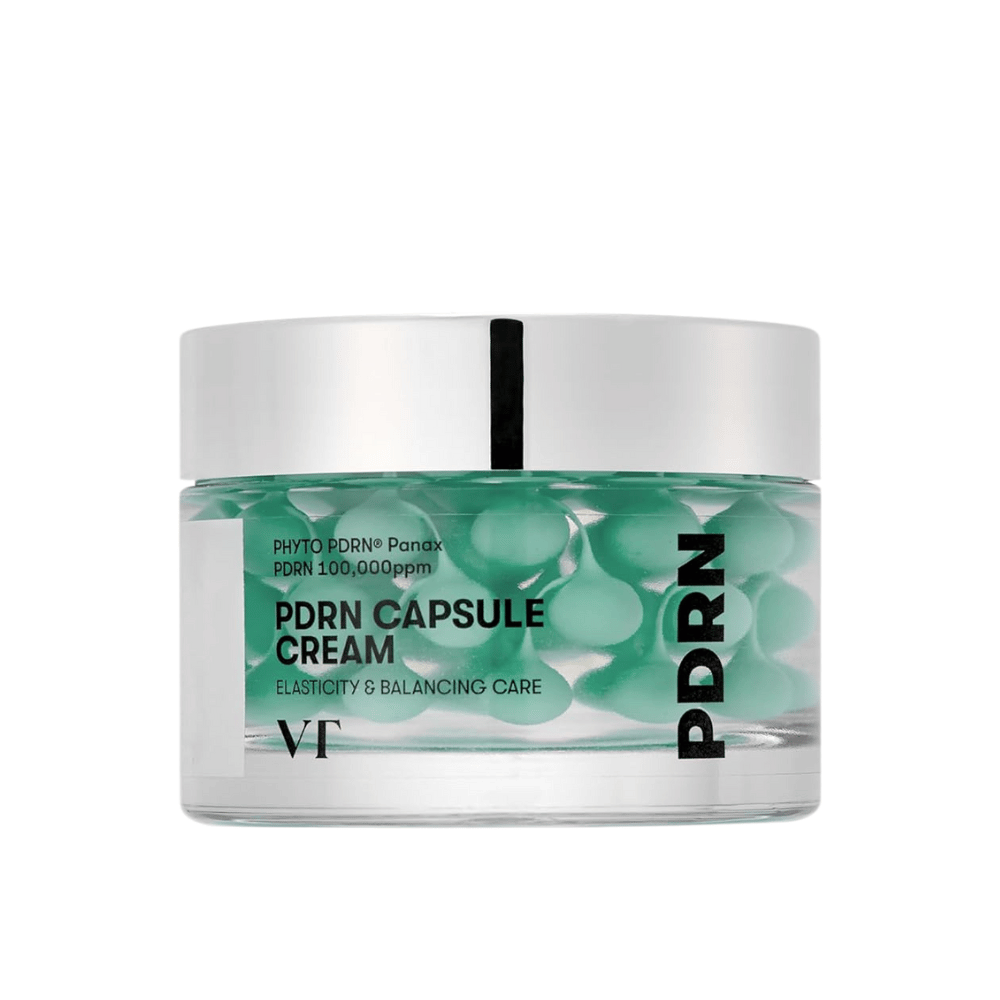VT PDRN Capsule Cream dans un pot transparent avec un couvercle argenté. Le contenu se compose de capsules vertes dans un gel clair, et l'étiquette indique que la crème est destinée à l'élasticité et aux soins équilibrants de la peau.