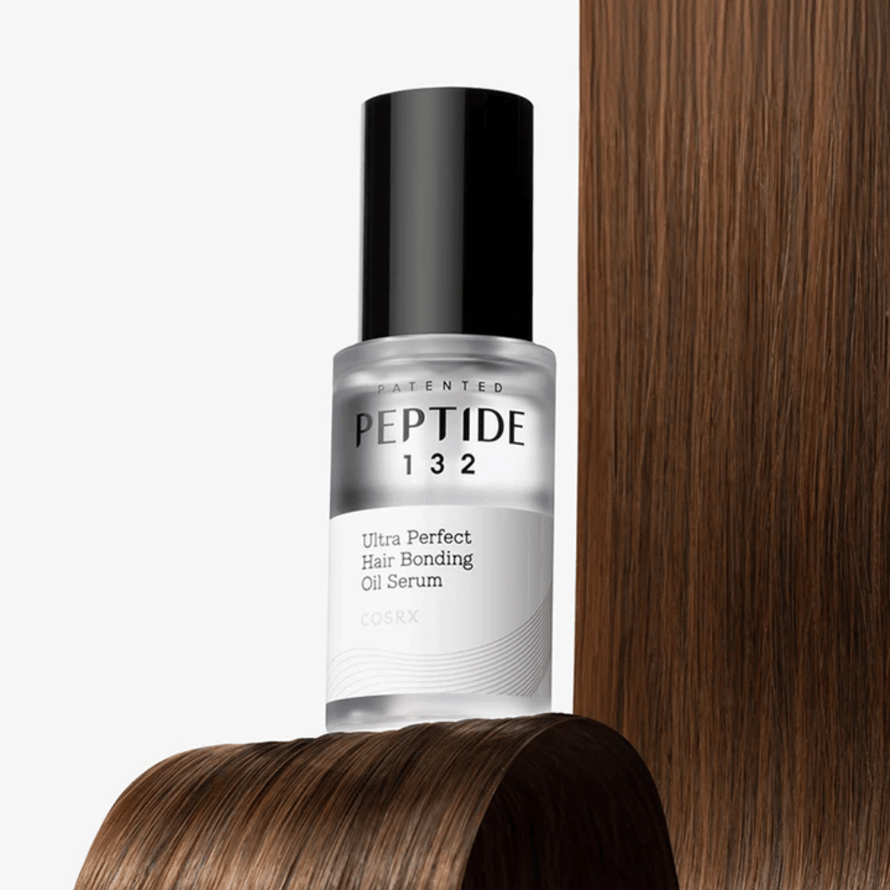 COSRX Peptide 132 Ultra Perfect Hair Bonding Oil Serum placée contre des cheveux brillants – offre force, douceur et brillance.
