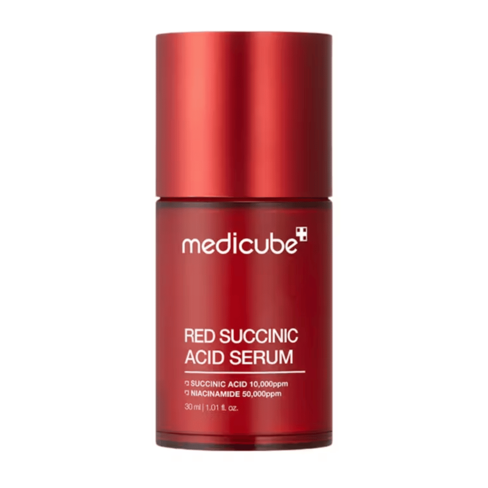 Medicube Sérum à l'acide succinique rouge dans une élégante bouteille rouge avec texte indiquant une teneur en acide succinique de 10 000 ppm et en niacinamide de 50 000 ppm, 30 ml. Conçu pour les peaux sujettes à l'acné et le soin des pigments.