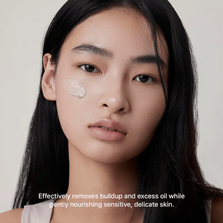 Modèle avec Arencia Rice + LHA Pore Control Rice Cake Cleanser appliqué sur la joue, nettoyant visage doux qui élimine efficacement la saleté et l'excès de sébum sans dessécher la peau.
