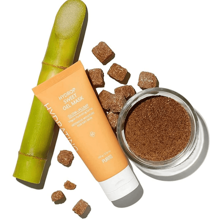 Un Hydrop Sweet Gel Mask 100g de PURITO, contenant un tube d'autobronzant sans soleil et un tube d'huile de coco, tous deux avec des propriétés améliorant la texture de la peau et hydratantes, le tout emballé dans